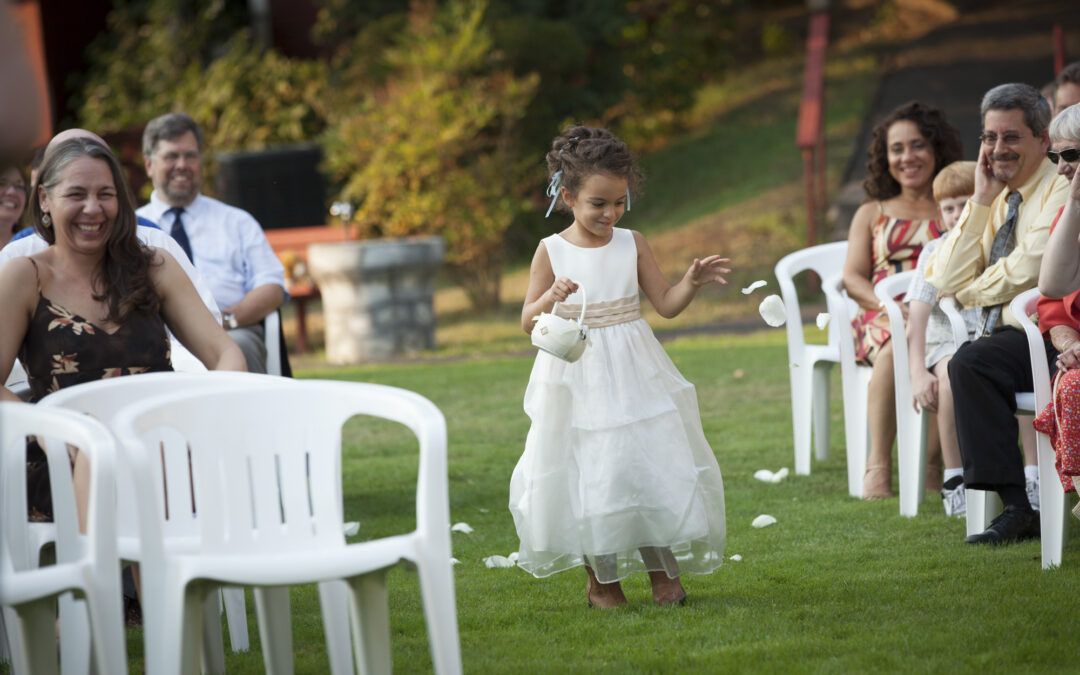 girl spreads flower petals in advance of wedding party