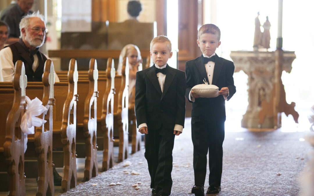 two young boys bring ring into Catholic church