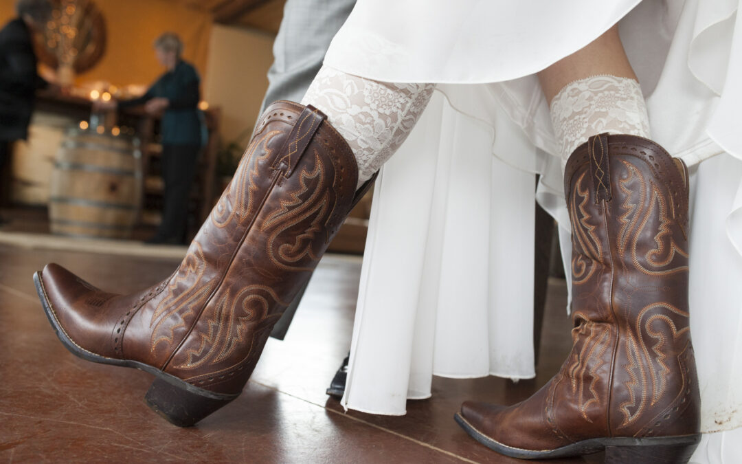 bride showing off the boots she is wearing at her ceremony