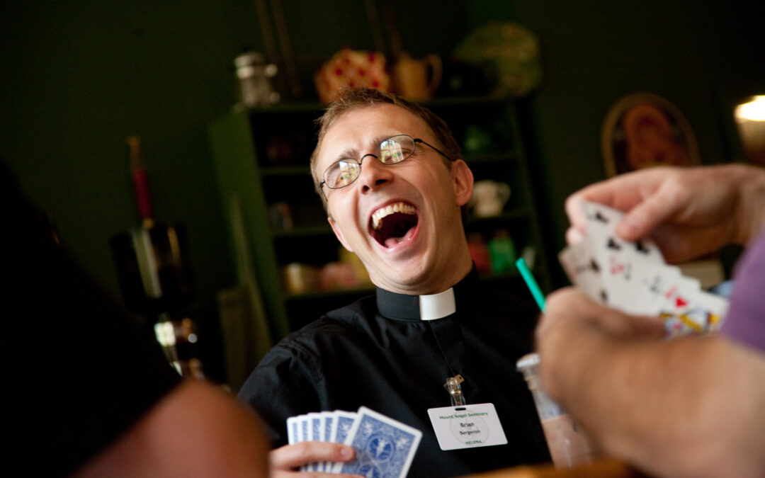 seminary student laughs during card game