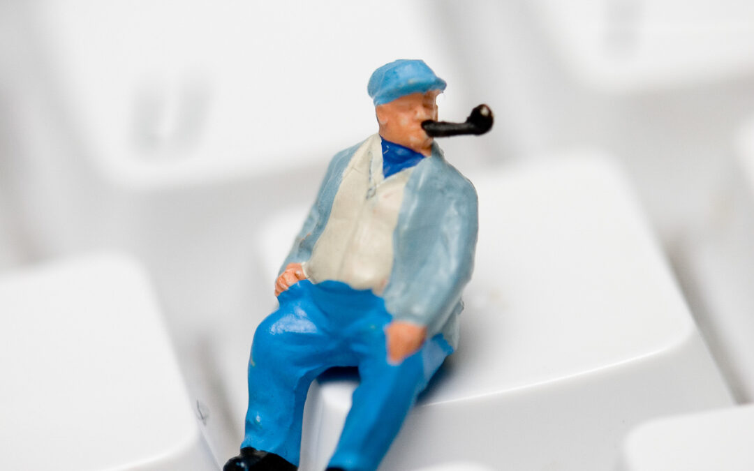 tiny model of a man smoking a pipe on a keyboard