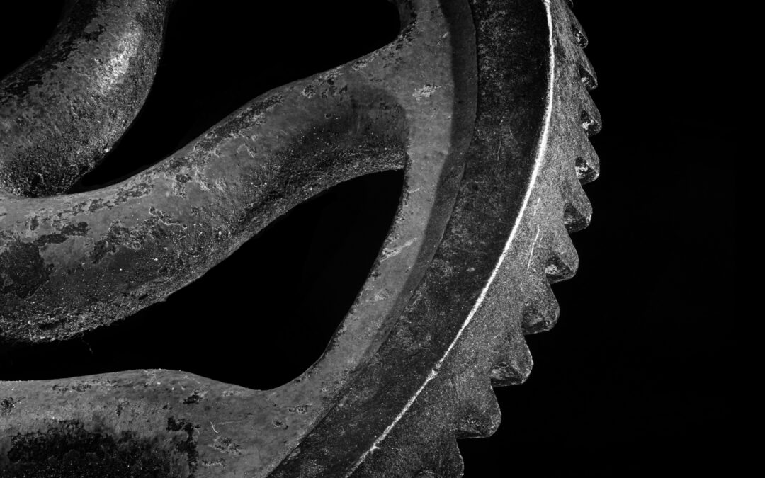 dramatic black and white photo of gear mechanism in vintage hand drill
